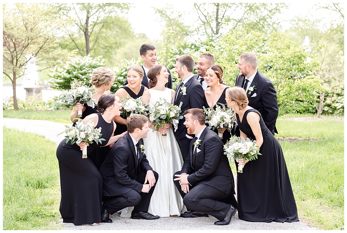 bridal party grouped together in forest park