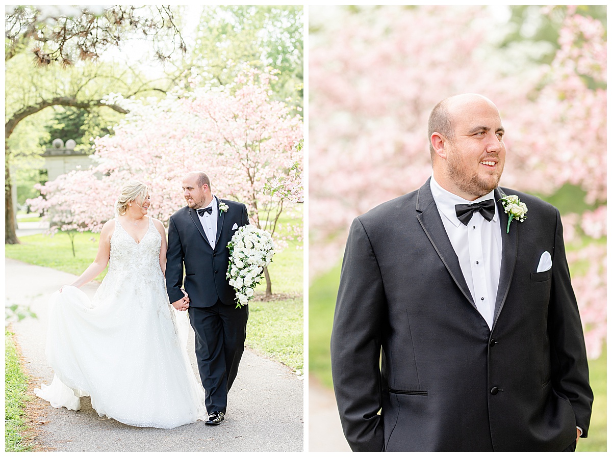 bride and groom walking through blooming trees in tower grove park