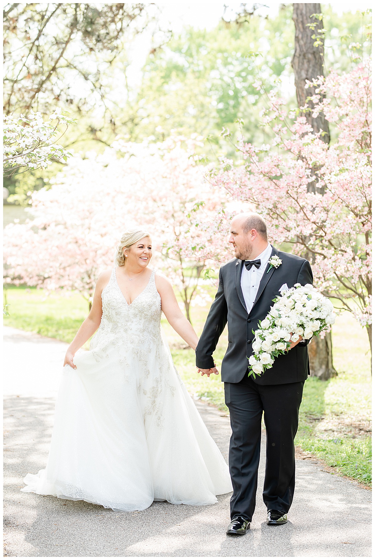 bride and groom walking during the spring in tower grove park