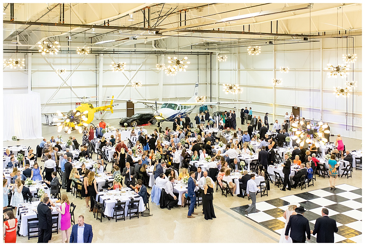 guests at airplane hangar wedding