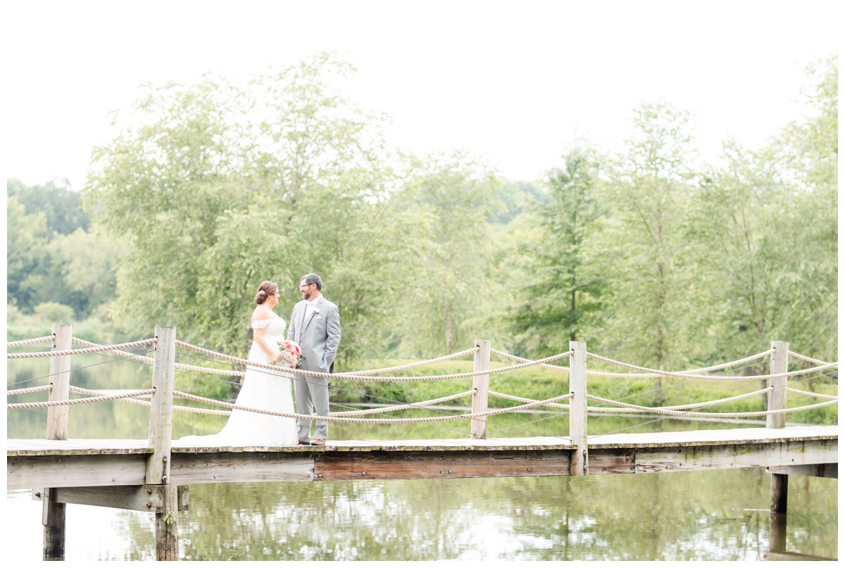 bride and groom on bridge at Cedar Creek