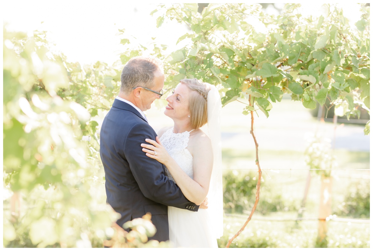 bride and groom in cedar lake cellars vineyard