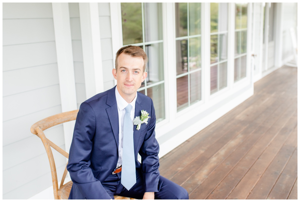 groom sitting on porch at Sunflower Hill Farm