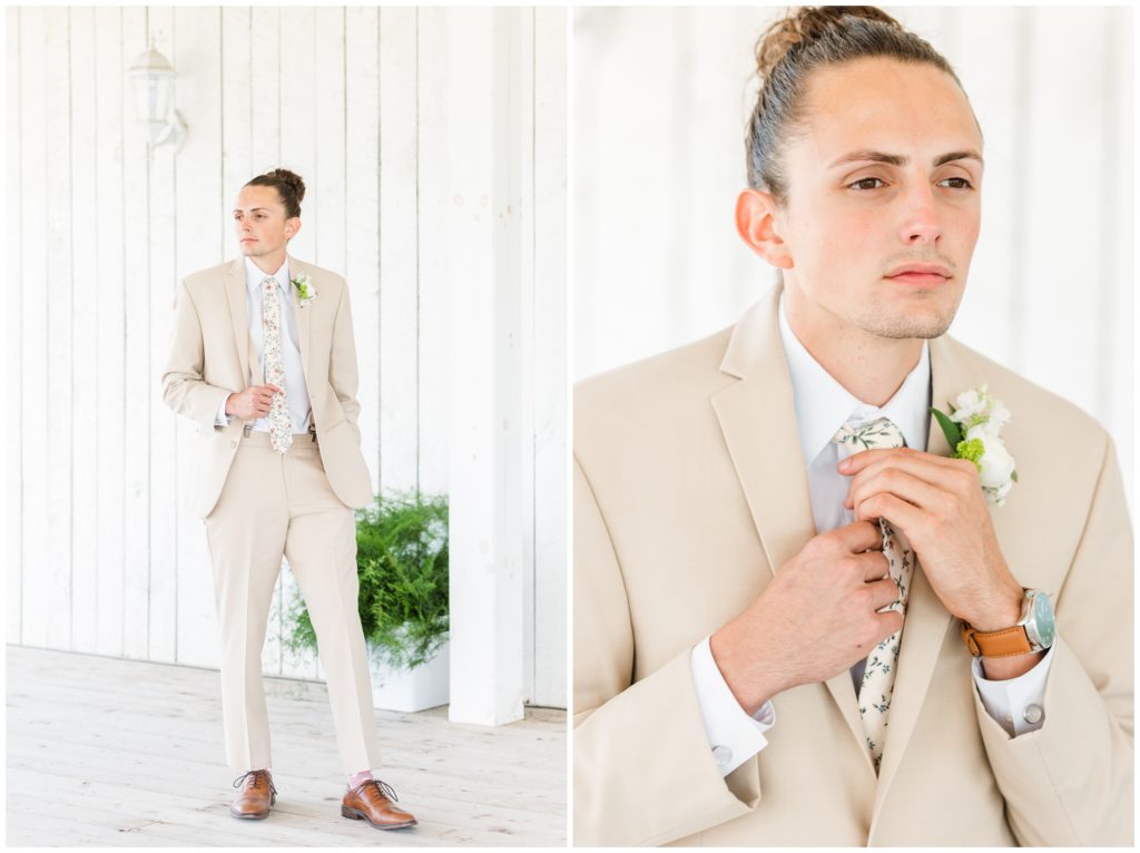 The groom poses in his khaki suit with white shirt and floral tie. 