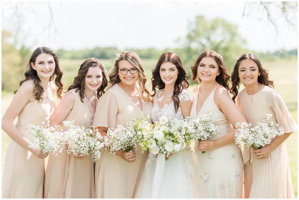 The bride poses with her bridesmaids. 