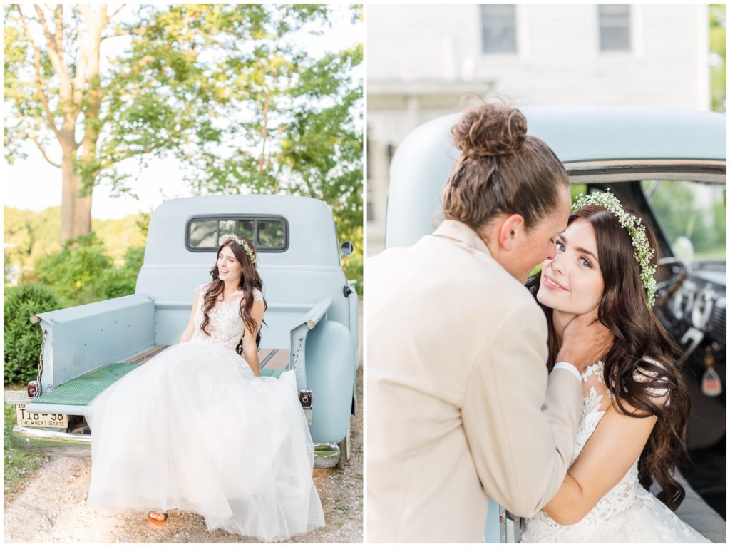 The bride and groom pose in a wedding portrait in front of a pale blue antique truck. 