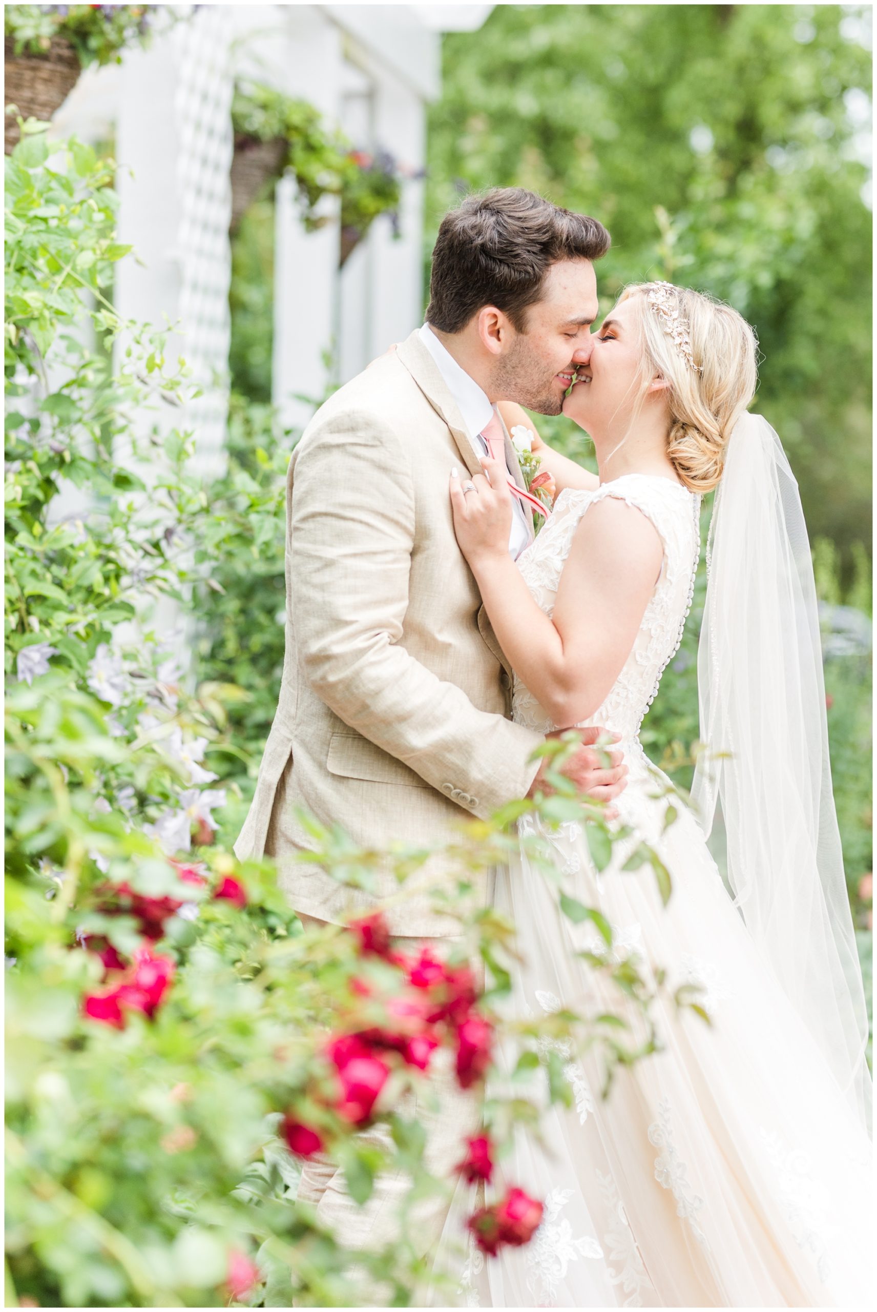 The bride and groom kiss in a portrait. 