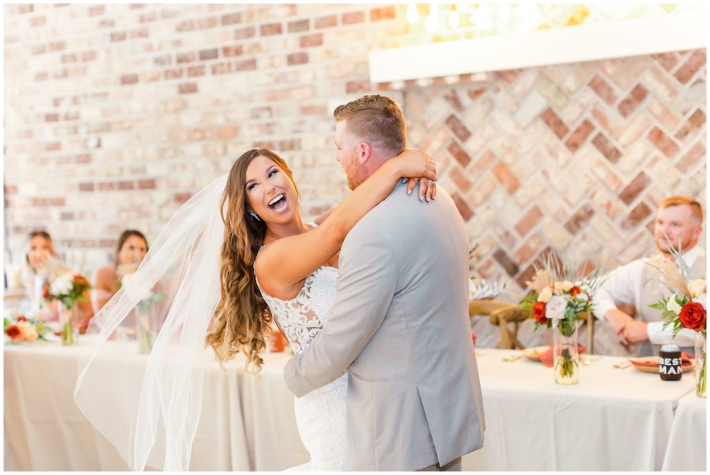 The bride and groom are all smiles during their first dance at their loveland estates wedding. 