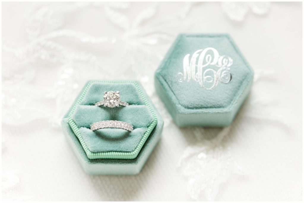 The bride's white gold ring set is set in a light turquoise monogrammed ring box. 