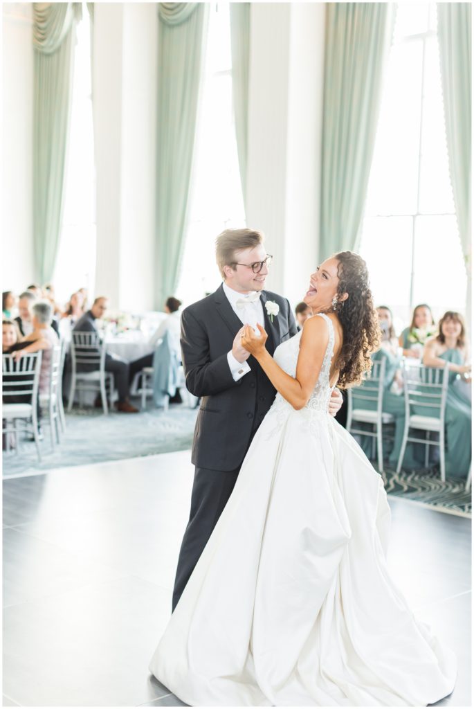 The bride and groom enjoy their first dance at their Marriott St. Louis Grand wedding reception. 