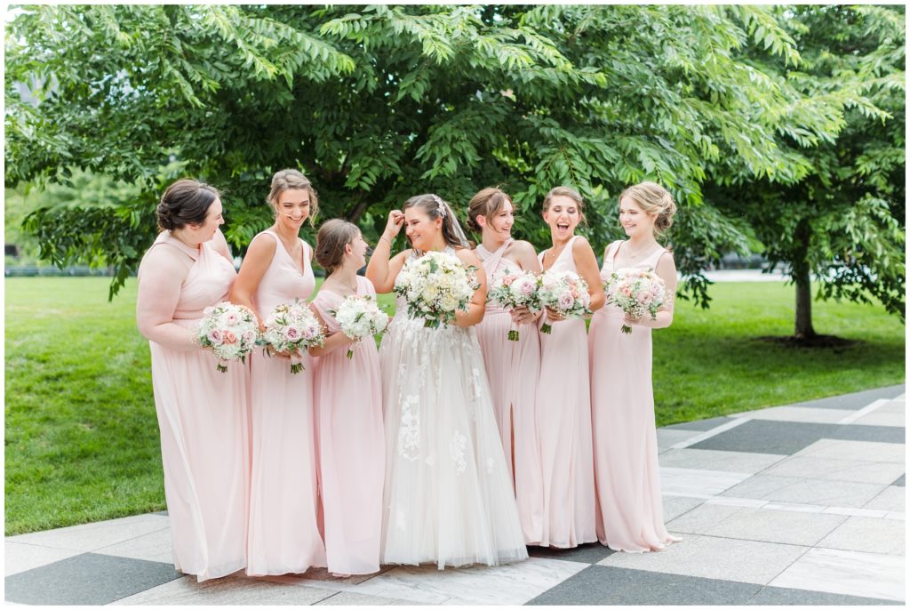 The bride and her bridesmaids take a candid shot. 