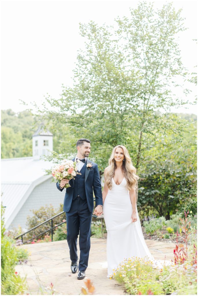 The bride and groom pose for a photo at their Sunflower Hill Farm wedding