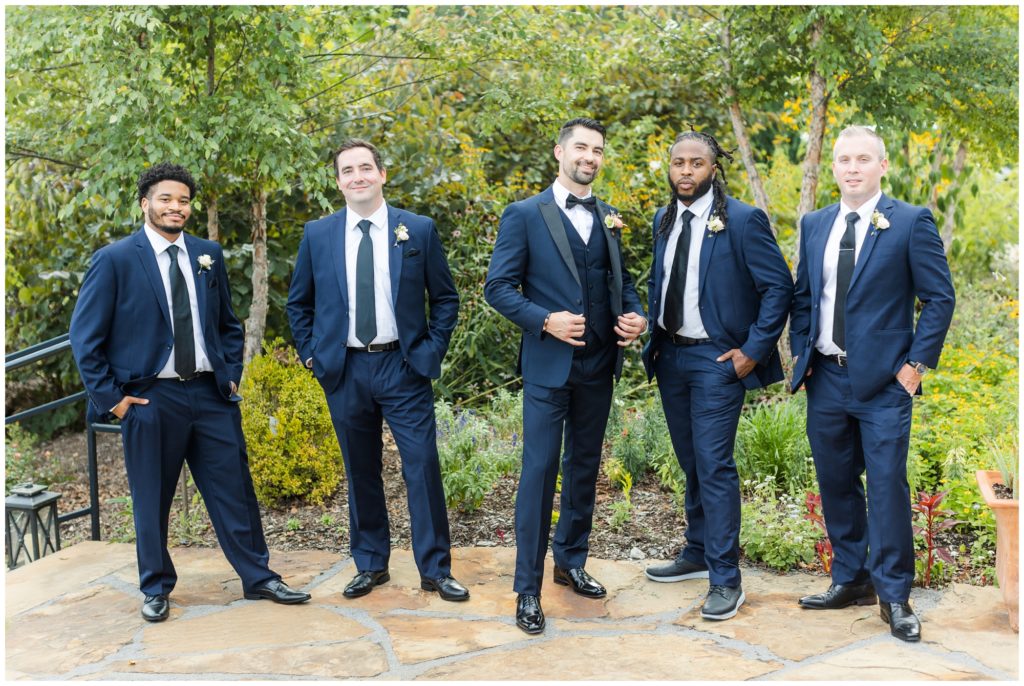 The groom's attendants pose in their blue suits. 