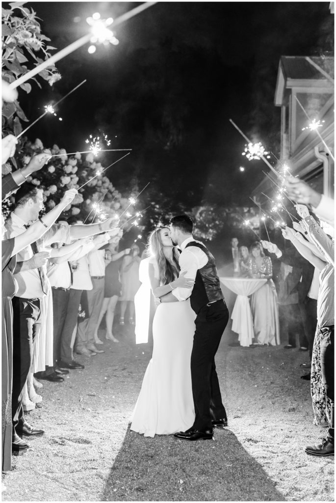 The sparkler wedding exit, sealed with a kiss during a wedding at Sunflower Hill Farm