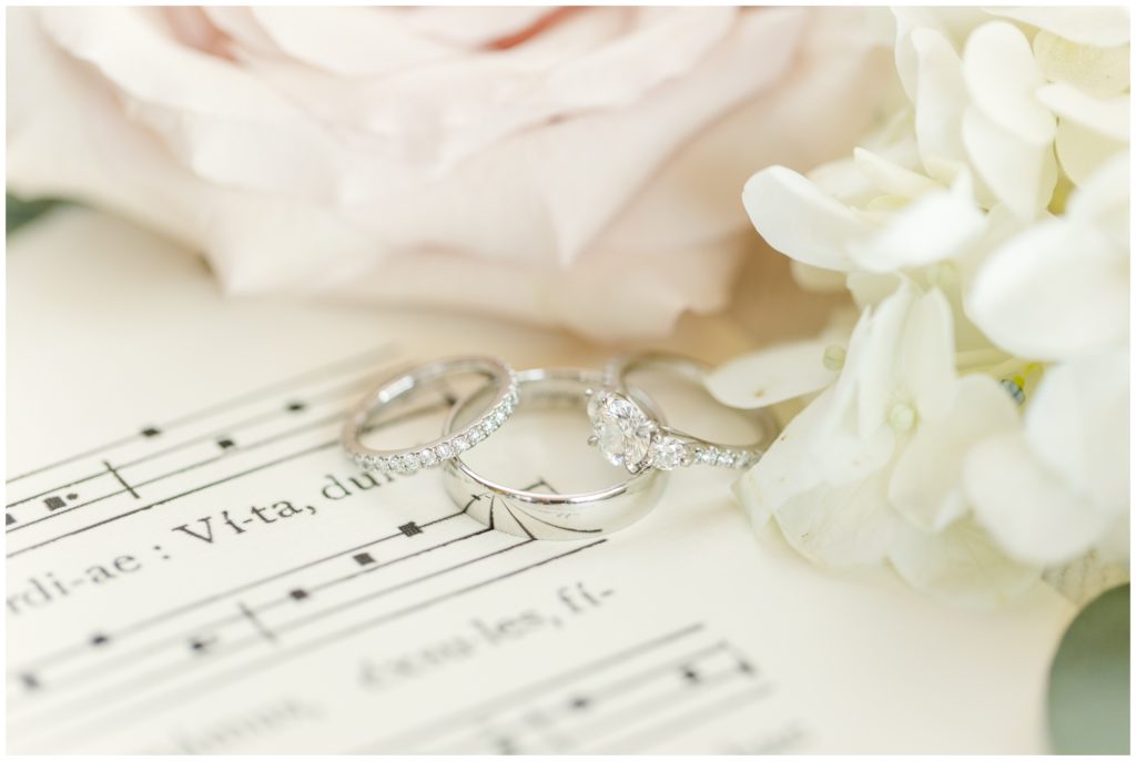 Bridal jewelry is displayed on sheet music.