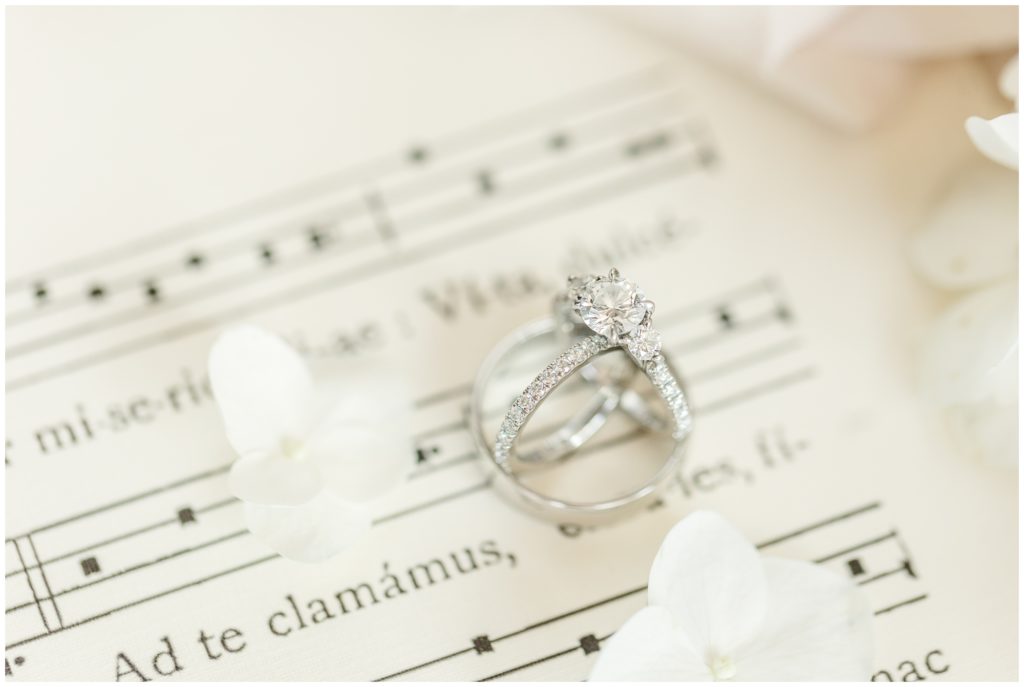 Bridal jewelry is displayed on sheet music.