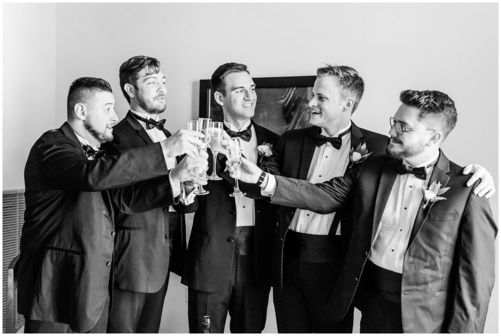 The groom and his groomsmen toast. 